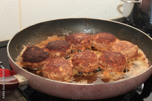 Frying meatballs in pan