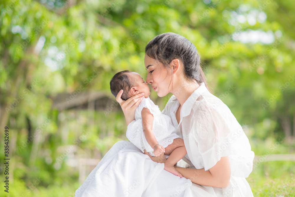 Asian beautiful mother hugs her baby while sleeping Asian beautiful mother hugs her baby while sleeping