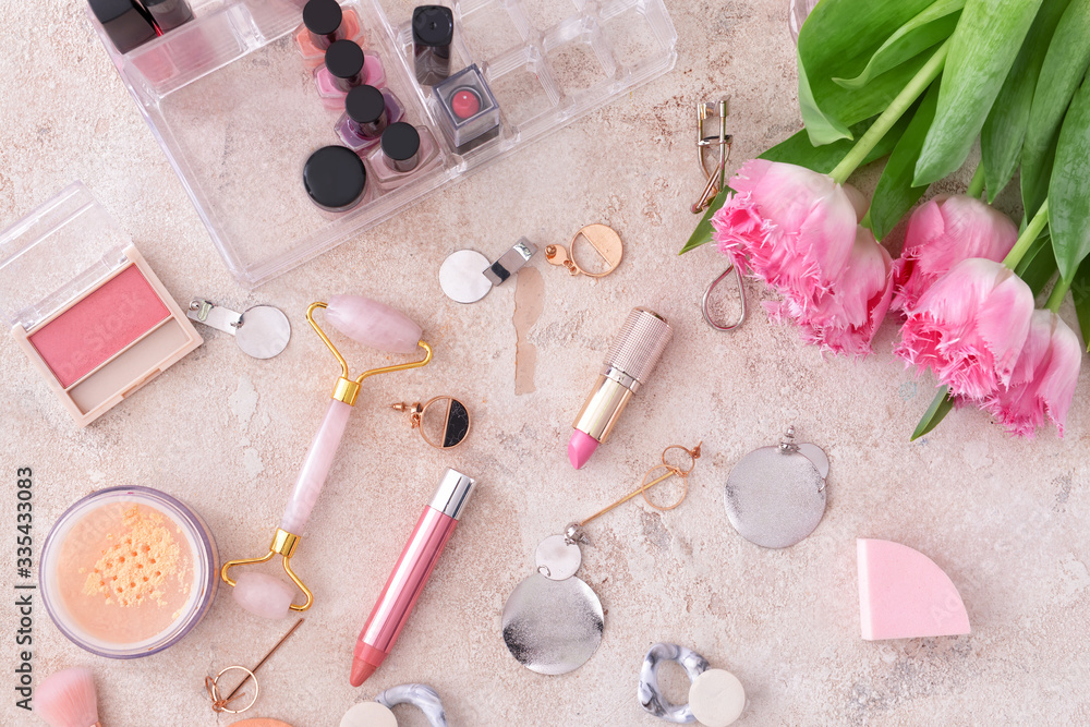 Makeup cosmetics with accessories on grey background Makeup cosmetics with accessories on grey background