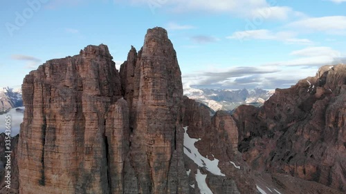 Drone aerial flying near Torre dei Scarperi mountain  in Tre Cime di Lavaredo national park in Sexten Dolomites Italy at sunrise. Hiking nature epic landscape in South Tirol. European Alps wanderlust. photo