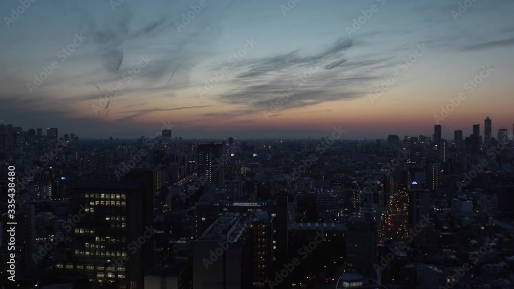 TOKYO, JAPAN - MAY 2020 : Aerial high angle sunrise scenery of CITYSCAPE of TOKYO around Shinjuku and Ikebukuro city. Long time lapse shot night to morning. Japanese urban metropolis concept. TOKYO, JAPAN - MAY 2020 : Aerial high angle sunrise scenery of CITYSCAPE of TOKYO around Shinjuku and Ikebukuro city. Long time lapse shot night to morning. Japanese urban metropolis concept.