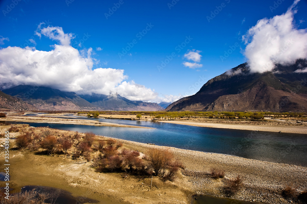 mountain and river landscape with blue sky and clouds, Tibet, China 