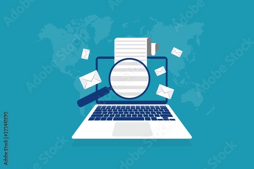 Magnifying glass looking through email on laptop computer sent or received worldwide