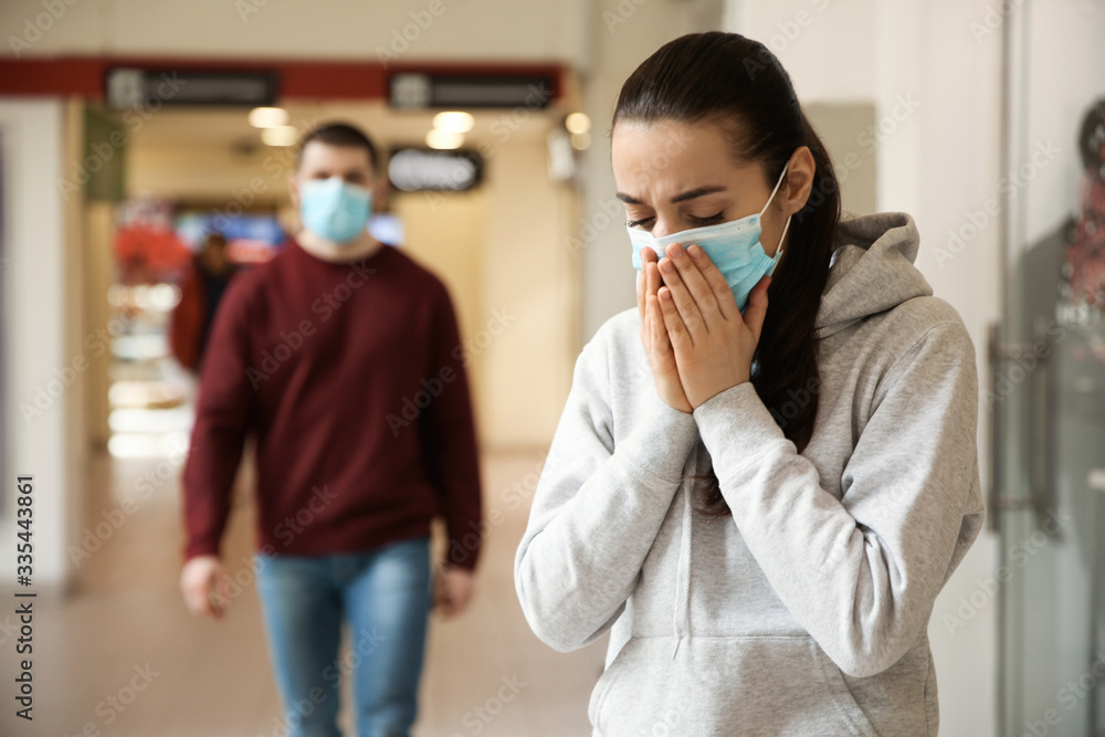People wearing disposable masks indoors. Dangerous virus