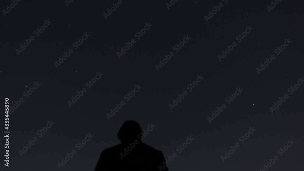 silhouette of a man walking in the night