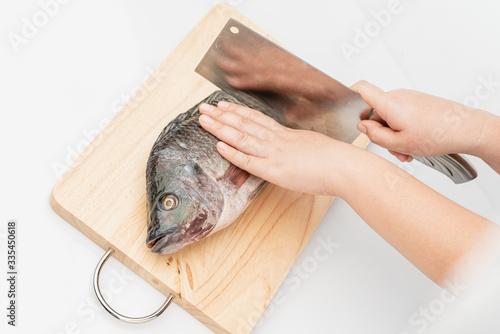 Tilapia is a eviscerated fish with a knife.
