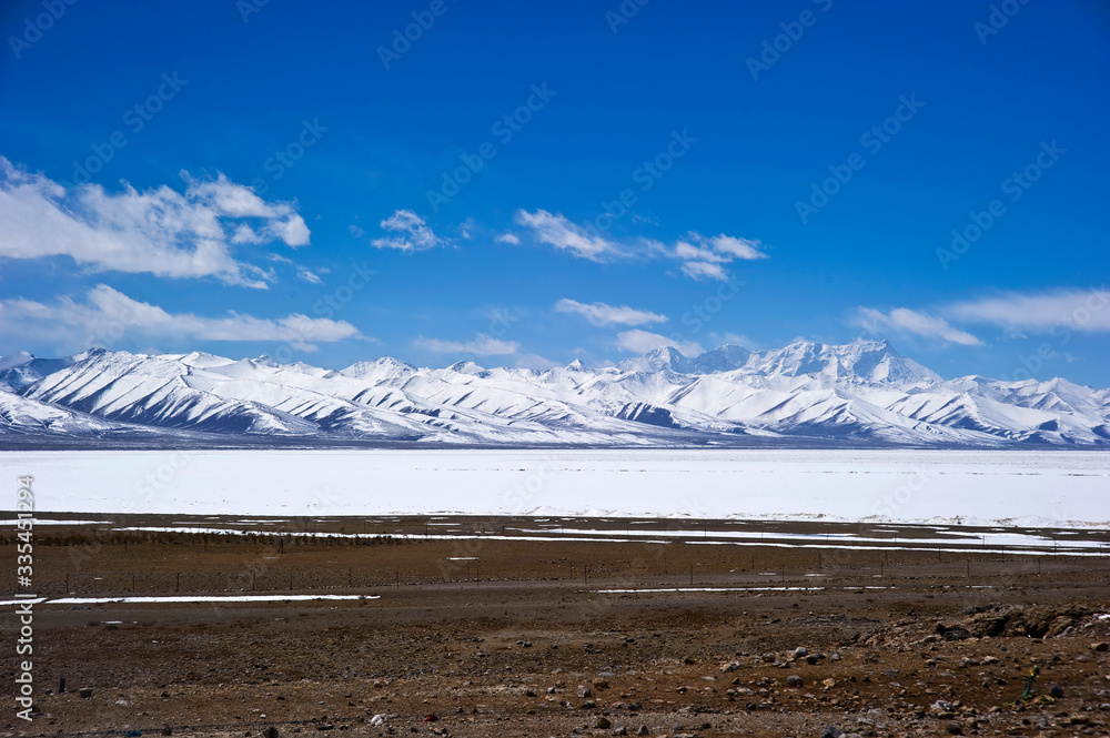 iced lake and snow covered mountains in winter, Tibet China