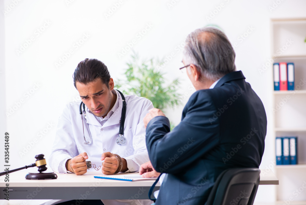 Male doctor in courthouse meeting with lawyer Male doctor in courthouse meeting with lawyer