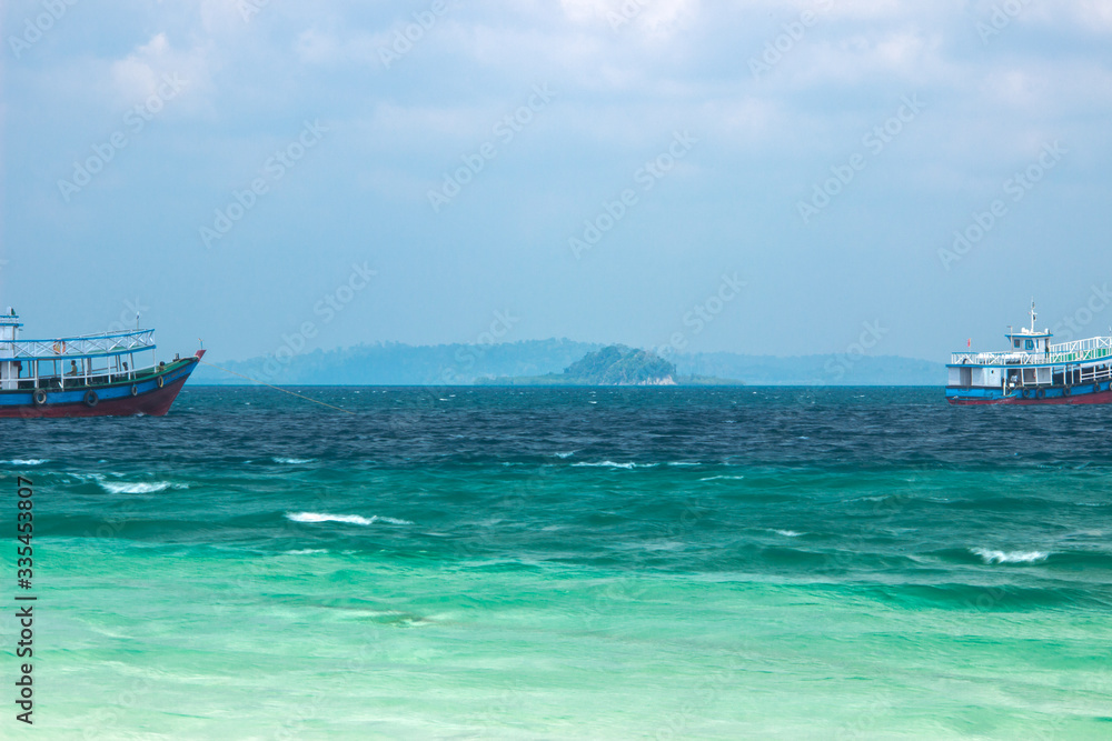 A shot of three coloured Andaman water with passenger boats A shot of three coloured Andaman water with passenger boats