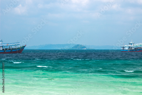 A shot of three coloured Andaman water with passenger boats © Lazy Guruji