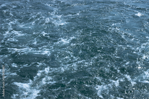 A shot of chaotic water behind ship