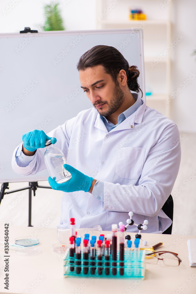 Young male chemist working in the lab Young male chemist working in the lab