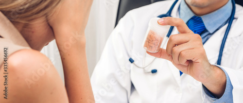 Doctor holding pill with patient in hospital.healthcare and medicine © Art_Photo