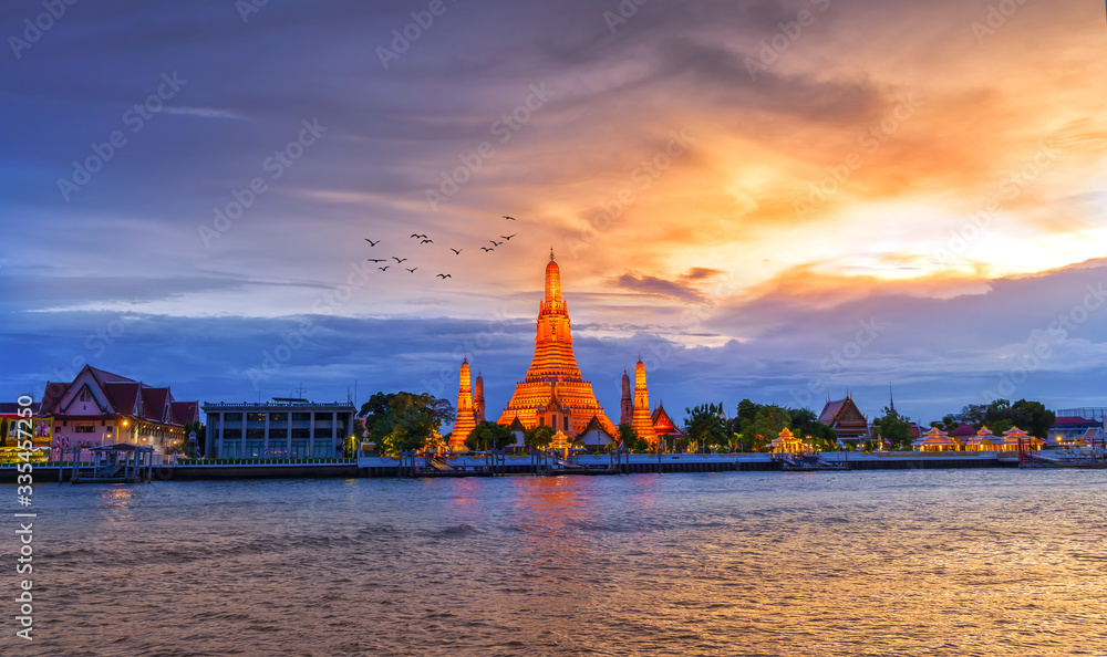 BANGKOK, THAILAND - JUNE 8, 2019 : Wat Arun Temple on the Chao Phraya River at sunset in Bangkok Thailand.  Wat Arun is a very popular place in Bangkok.