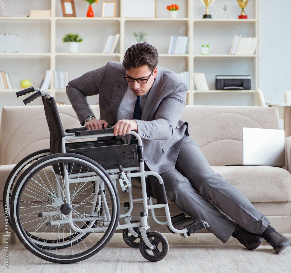 Dsabled businessman on wheelchair working home Dsabled businessman on wheelchair working home