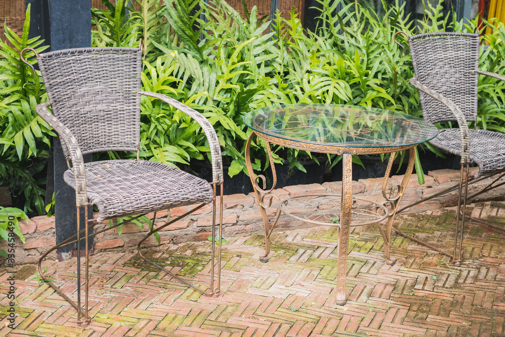 A vintage table and chairs are made wicker weave.