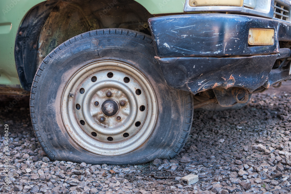 Old car with flat tire