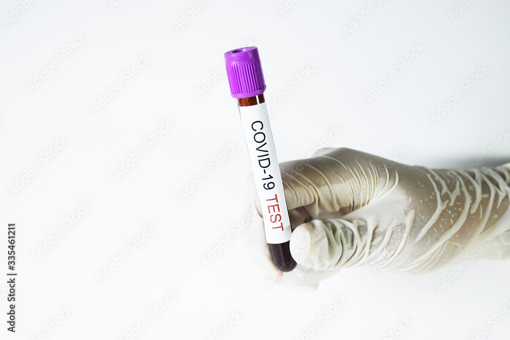 Obraz premium A doctor holding a blood tube on white background.