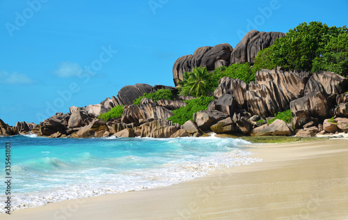 Grande Anse beach with big granite rocks in La Digue Island, Seychelles. Tropical landscape with sunny sky.