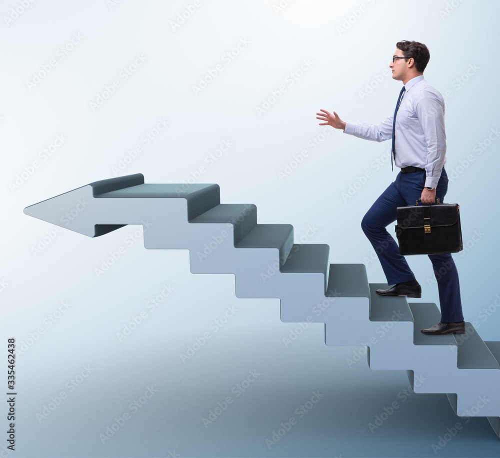 Businessman climbing career ladder in business concept Businessman climbing career ladder in business concept