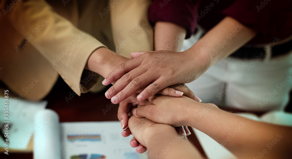 In selective focus ofhuman hands stacked together,business team,sign and symbol of collaborator,success deal,uniun and teamwork