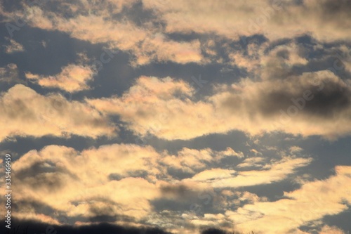 Fototapeta Naklejka Na Ścianę i Meble -  Golden Clouds Reflecting the Late Afternoon Sunshine