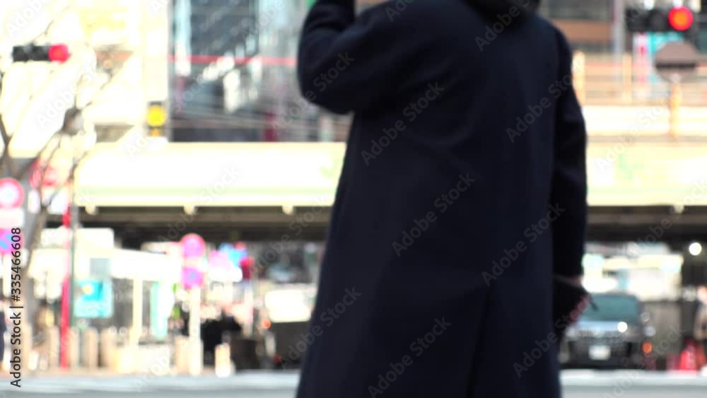 TOKYO, JAPAN - FEB 2020 : Crowd of people at Shibuya Scramble Crossing in busy weekend. Pedestrians (Japanese people and tourist) at the street. Focus in front. City lifestyle concept. Slow motion. TOKYO, JAPAN - FEB 2020 : Crowd of people at Shibuya Scramble Crossing in busy weekend. Pedestrians (Japanese people and tourist) at the street. Focus in front. City lifestyle concept. Slow motion.