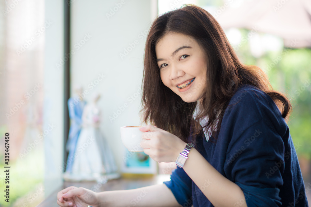 Business asian smart women drinking hot latte coffee and read book on couch Business asian smart women drinking hot latte coffee and read book on couch