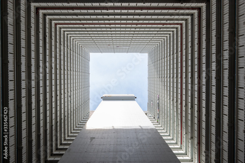 Look up view of an apartment from the center with symmetry in Asia #335467420
