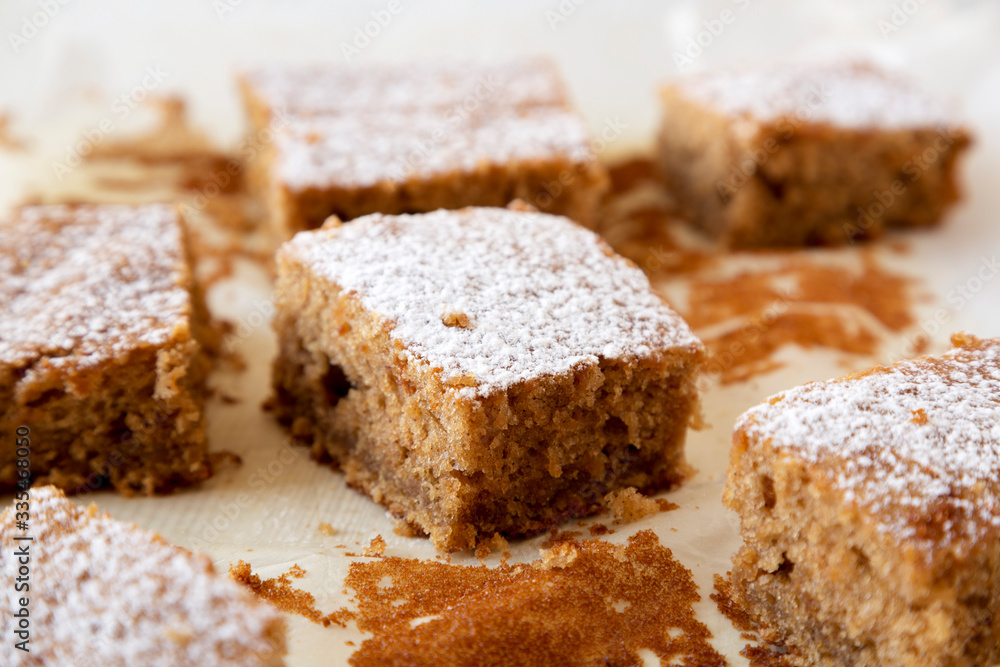 Homemade Tasty Applesauce Cake on a white plate, low angle view. Close-up.