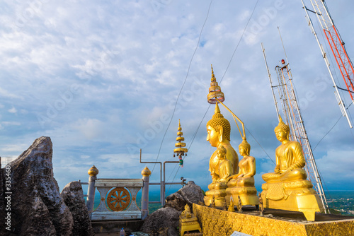 Golden statue on mountain sunruse with fog photo