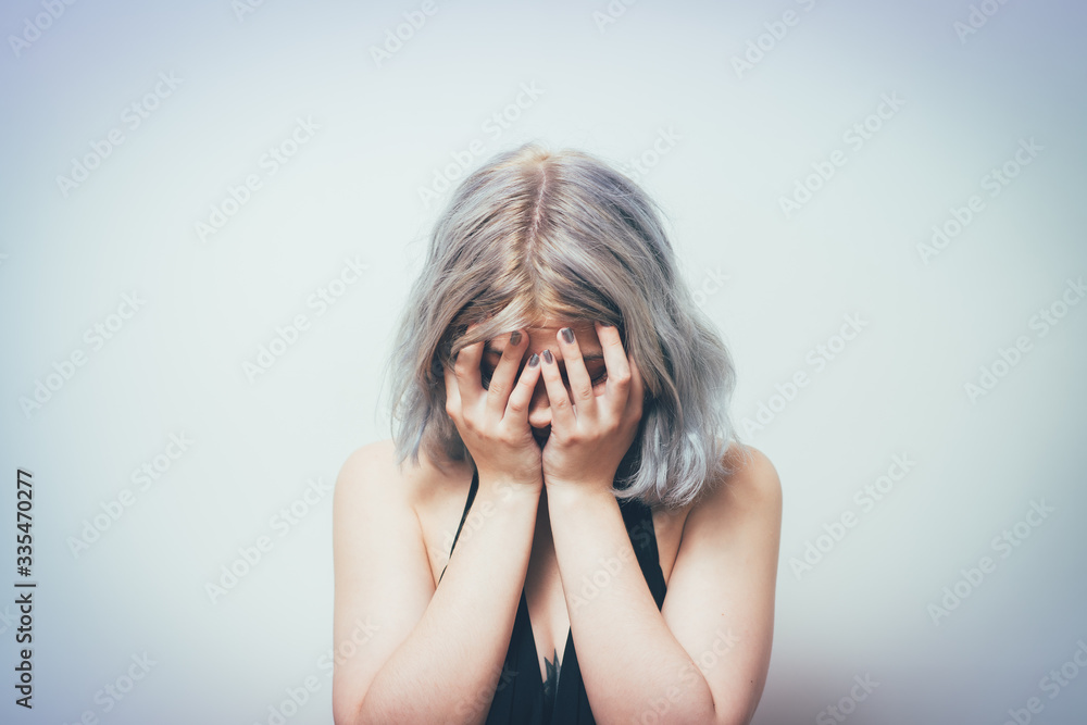 Fototapeta premium Woman covers his face by hand