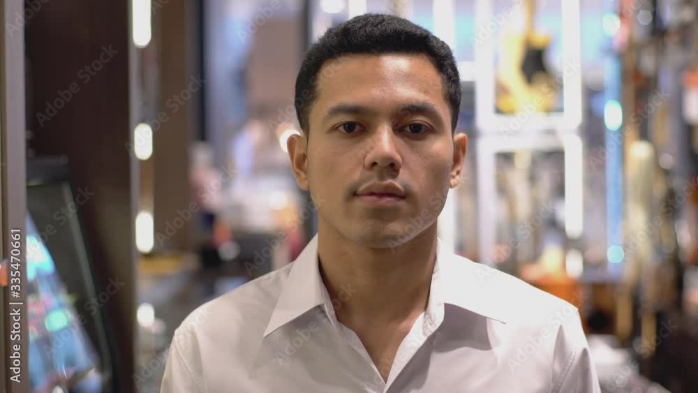 Close Up Portrait of a South East Asian Muslim man looking and smiling at camera with confidently Close Up Portrait of a South East Asian Muslim man looking and smiling at camera with confidently