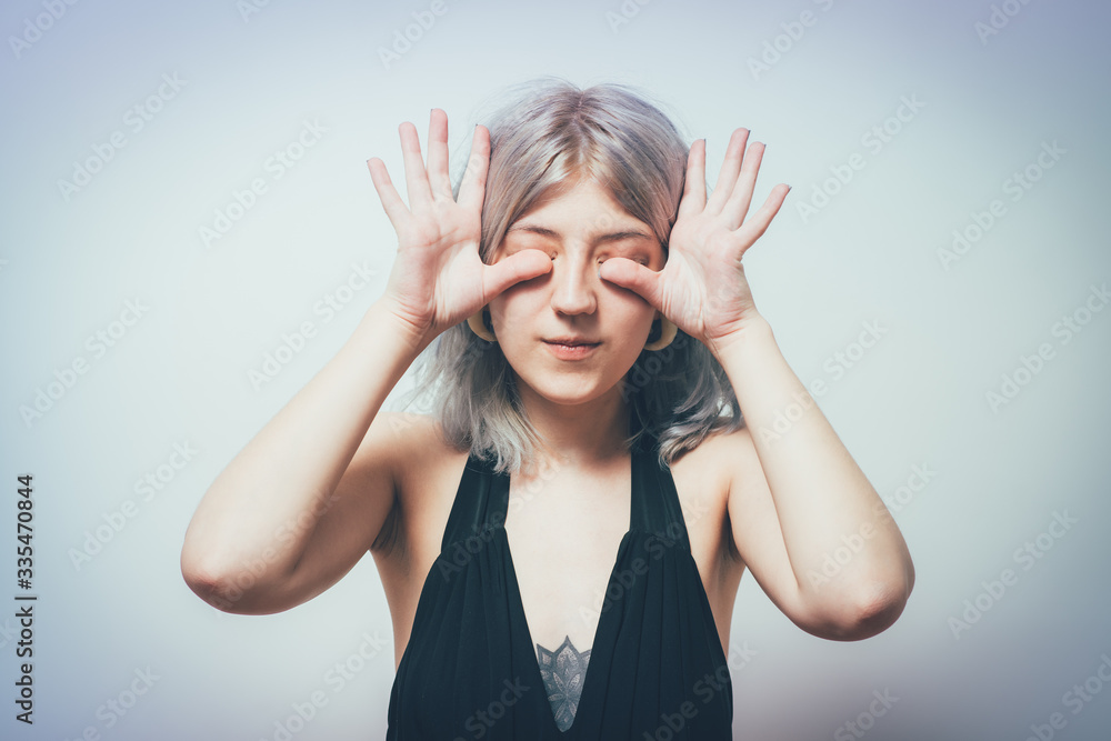 woman closes eyes with her hands woman closes eyes with her hands