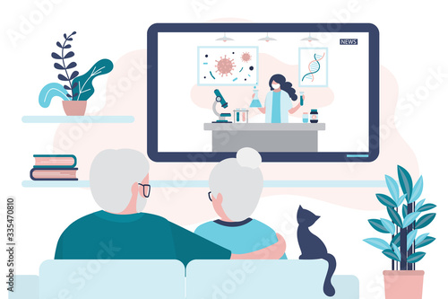 Elderly couple watch news on tv. Vaccine developer or female scientist on screen. Quarantine or self-isolation.