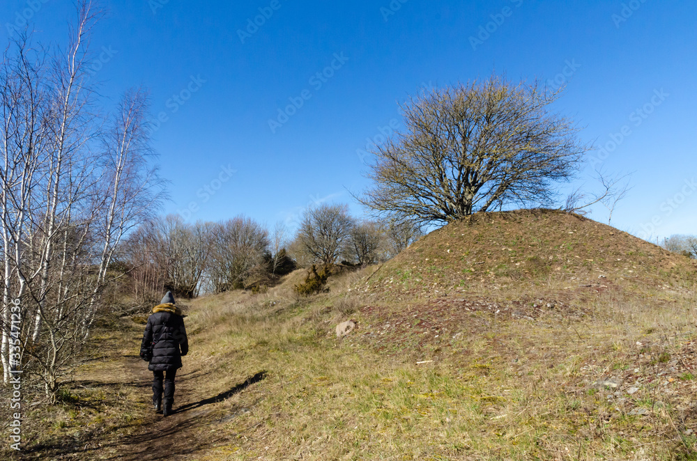 Woman walks on a footpath in spring season Woman walks on a footpath in spring season