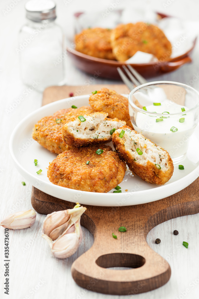 Delicious crispy fried breaded chicken patties with sauce. Delicious crispy fried breaded chicken patties with sauce.