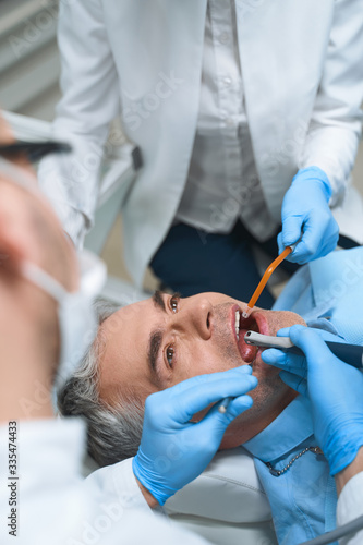 Man being treated at dentist stock photo