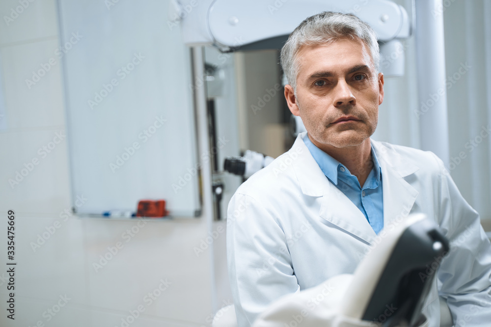 Expierenced man in dental office stock photo