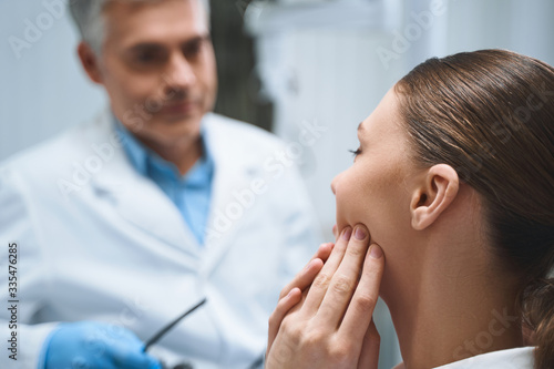 Woman coming to doctor because of toothache stock photo