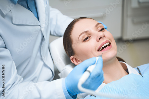 Happy woman during visit to dentist stock photo