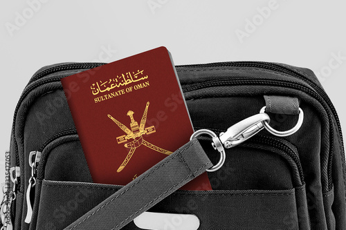 Close up of Oman Passport in Black Travel Bag Pocket