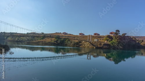 Beautiful lake in a country side with a footbridge and resort
