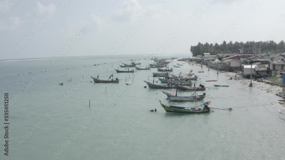 Aerial top down view of fishing long tail boats moored to the sea shore on island Koh Samui, Thailand. Fisherman village. Sunny day, azure water. Nature. Background. Wallpaper. Drone photography. Aerial top down view of fishing long tail boats moored to the sea shore on island Koh Samui, Thailand. Fisherman village. Sunny day, azure water. Nature. Background. Wallpaper. Drone photography.