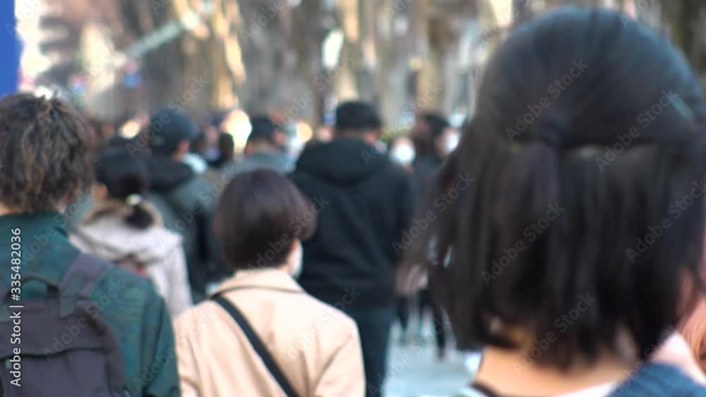 SHIBUYA WARD, TOKYO, JAPAN - FEB 2020 : View of back shot of unidentified crowd of people enjoying shopping at Harajuku, Omotesando area. Shot in busy weekend. Holiday concept. Slow motion shot. SHIBUYA WARD, TOKYO, JAPAN - FEB 2020 : View of back shot of unidentified crowd of people enjoying shopping at Harajuku, Omotesando area. Shot in busy weekend. Holiday concept. Slow motion shot.