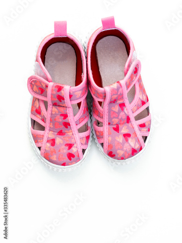 Cute pink baby girl shoes isolated on white background/ Top view/ Baby clothes