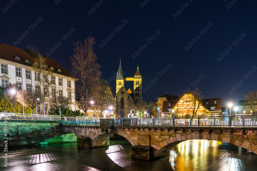 Germany, Medieval city esslingen am neckar in magical atmosphere by night with starry sky and illuminated buildings and bridge over river