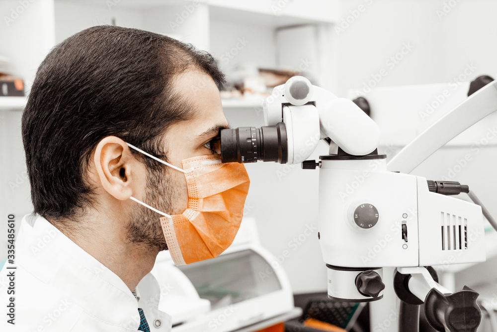Young male dentist doctor at his workplace. Professional uniform and equipment of a dentist. Healthcare Equipping a doctor’s workplace. Dentistry Young male dentist doctor at his workplace. Professional uniform and equipment of a dentist. Healthcare Equipping a doctor’s workplace. Dentistry