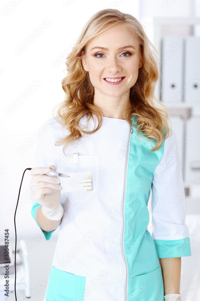 Portrait of professional female beautician standing straight in beauty salon. Makeup artist ready to do eyebrow permanent tattoo at any woman face. Portrait of professional female beautician standing straight in beauty salon. Makeup artist ready to do eyebrow permanent tattoo at any woman face.