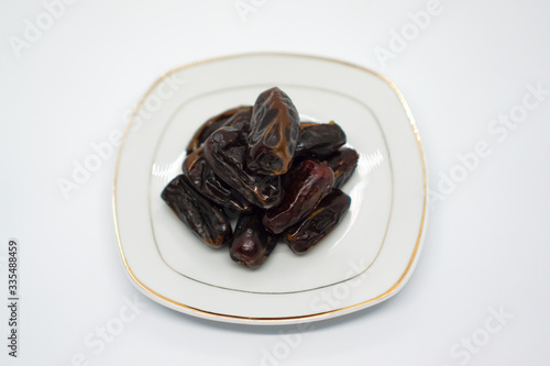 Dates in a dish with a white background